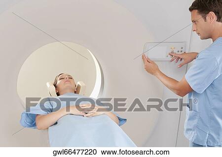 Patient going through an MRI scan View Large Photo Image Stock Image - Patient going through an MRI scan. Fotosearch