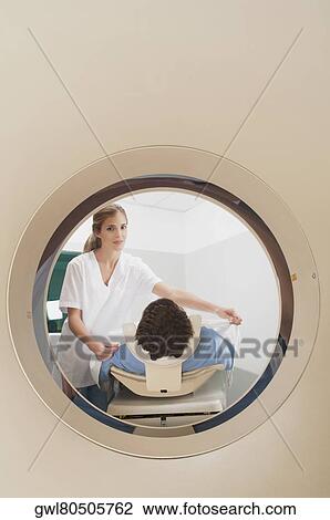 Patient going through an MRI scan View Large Photo Image Stock Image - Patient going through an MRI scan. Fotosearch
