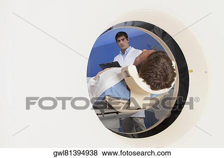 Patient going through an MRI scan View Large Photo Image Stock Photo - Patient going through an MRI scan. Fotosearch