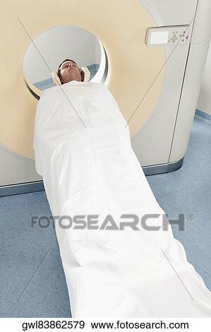 Patient going through an MRI scan View Large Photo Image Stock Photo - Patient going through an MRI scan. Fotosearch