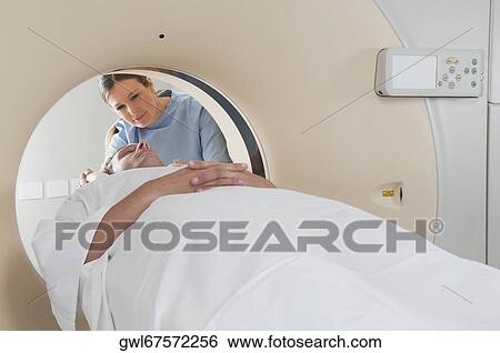 Patient going through an MRI scan View Large Photo Image Stock Photograph - Patient going through an MRI scan. Fotosearch