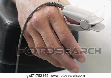 Stock Photography - Patient's thumb with pulse oxymeter. Fotosearch