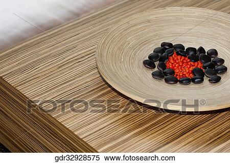 Pebbles in a wooden plate on a table View Large Photo Image Stock Photography - Pebbles in a wooden plate on a table. Fotosearch