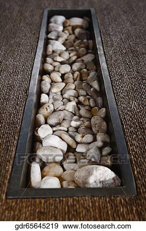 Pebbles on a table View Large Photo Image Stock Photo - Pebbles on a table. Fotosearch