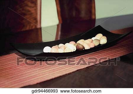 Pebbles on a tray on a table View Large Photo Image Stock Image - Pebbles on a tray on a table. Fotosearch