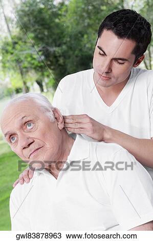 Physiotherapist examining a man View Large Photo Image Stock Image - Physiotherapist examining a man. Fotosearch