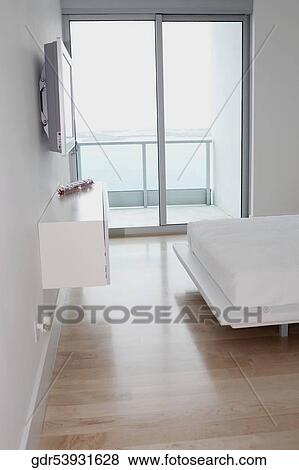 Plasma television in a bedroom View Large Photo Image Stock Photo - Plasma television in a bedroom. Fotosearch