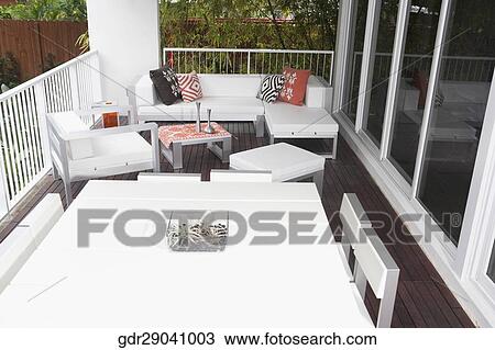Stock Image - Porch of a house with furniture. Fotosearch