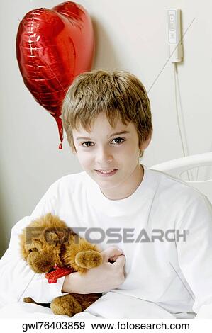 Portrait of a boy sitting on a hospital bed View Large Photo Image Stock Photo - Portrait of a boy sitting on a hospital bed. Fotosearch