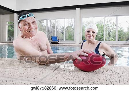 Portrait of a couple smiling in a swimming pool View Large Photo Image Stock Photograph - Portrait of a couple smiling in a swimming pool . Fotosearch