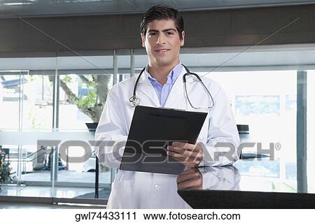 Portrait of a doctor holding a clipboard View Large Photo Image Stock Image - Portrait of a doctor holding a clipboard. Fotosearch