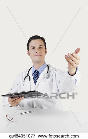 Portrait of a doctor holding a clipboard View Large Photo Image Stock Photo - Portrait of a doctor holding a clipboard. Fotosearch