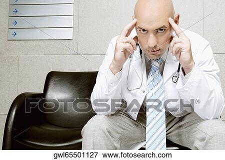 Portrait of a doctor thinking View Large Photo Image Stock Photo - Portrait of a doctor thinking. Fotosearch