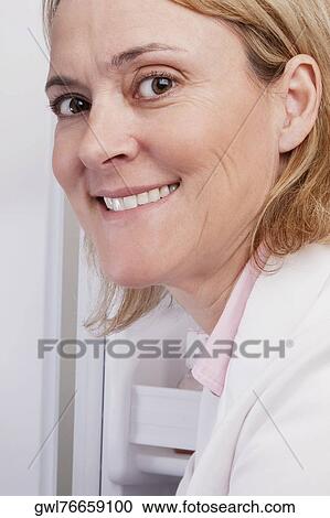 Portrait of a female doctor smiling in a laboratory View Large Photo Image Stock Image - Portrait of a female doctor smiling in a laboratory. Fotosearch