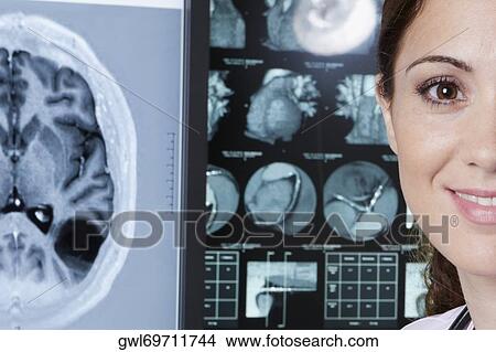 Portrait of a female doctor with MRI report View Large Photo Image Picture - Portrait of a female doctor with MRI report. Fotosearch