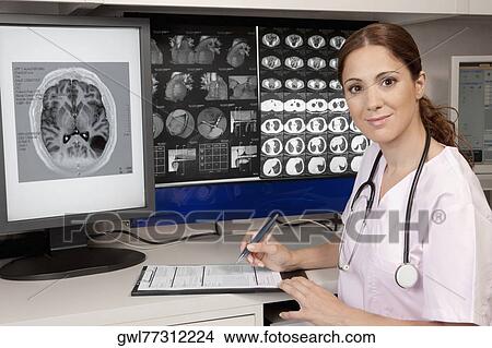 Portrait of a female doctor with MRI report View Large Photo Image Picture - Portrait of a female doctor with MRI report. Fotosearch