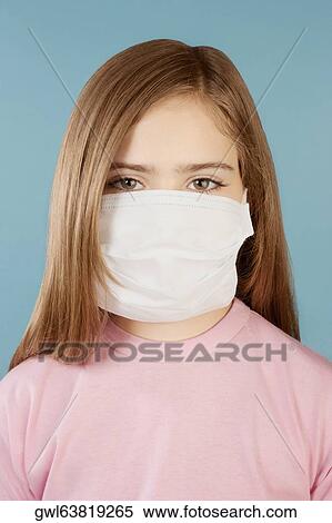 Stock Photography - Portrait of a girl wearing a flu mask. Fotosearch