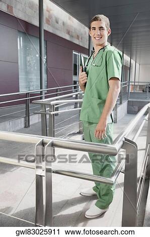 Portrait of a male nurse smiling View Large Photo Image Stock Image - Portrait of a male nurse smiling. Fotosearch