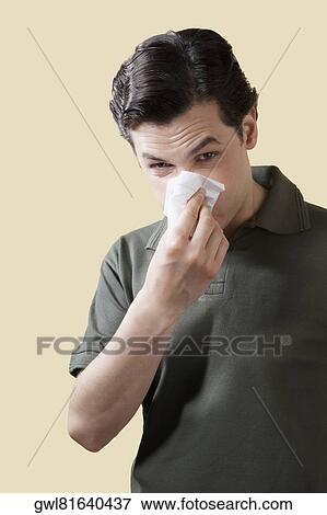 Portrait of a man blowing his nose View Large Photo Image Stock Photo - Portrait of a man blowing his nose. Fotosearch
