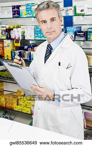 Portrait of a pharmacist holding a clipboard View Large Photo Image Stock Photo - Portrait of a pharmacist holding a clipboard. Fotosearch