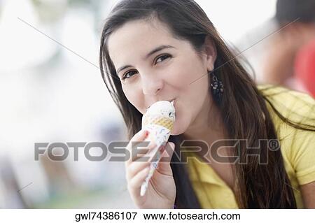 Portrait of a teenage girl eating an ice cream View Large Photo Image Stock Photo - Portrait of a teenage girl eating an ice cream. Fotosearch