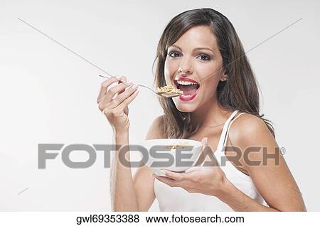 Portrait of a woman eating cereal View Large Photo Image Stock Photo - Portrait of a woman eating cereal. Fotosearch