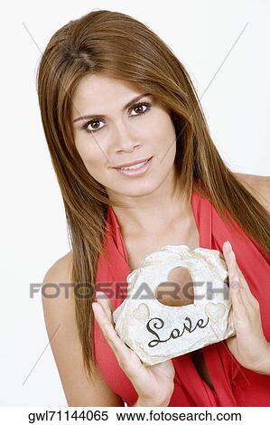 Portrait of a woman holding a gift View Large Photo Image Stock Photography - Portrait of a woman holding a gift. Fotosearch
