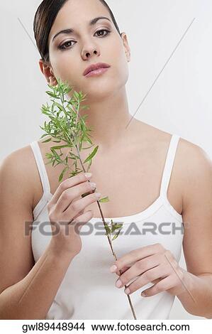 Picture - Portrait of a woman holding aroma herbs. Fotosearch