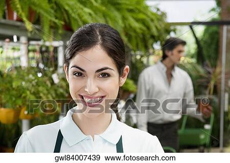 Portrait of a woman in a greenhouse View Large Photo Image Stock Photo - Portrait of a woman in a greenhouse. Fotosearch