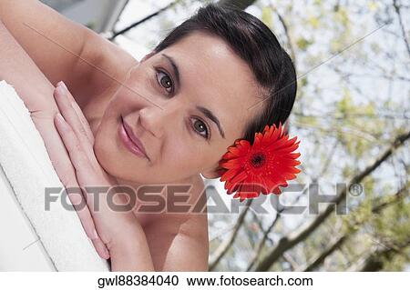 Stock Image - Portrait of a woman lying on a massage table. Fotosearch