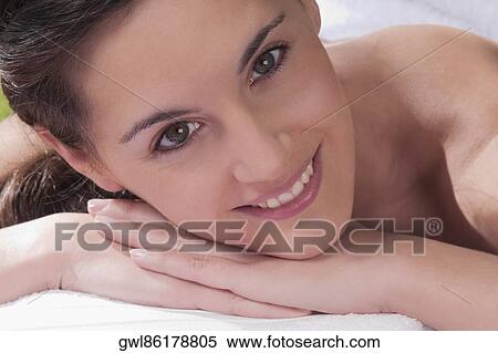 Portrait of a woman lying on a massage table View Large Photo Image Stock Photography - Portrait of a woman lying on a massage table. Fotosearch