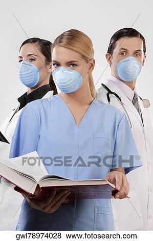 Portrait of doctors wearing flu masks View Large Photo Image Stock Photo - Portrait of doctors wearing flu masks. Fotosearch