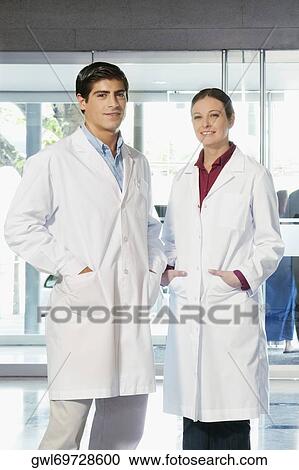 Portrait of two doctors standing together and smiling View Large Photo Image Stock Image - Portrait of two doctors standing together and smiling. Fotosearch