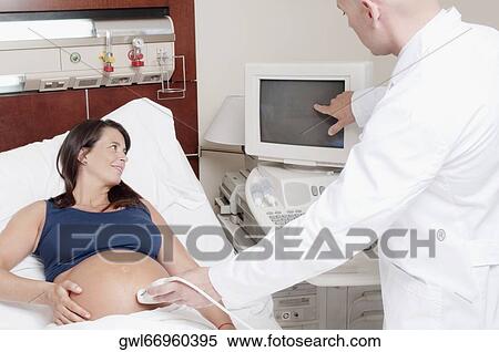 Pregnant woman going through an ultrasound scan View Large Photo Image Stock Photography - Pregnant woman going through an ultrasound scan. Fotosearch