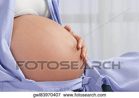 Pregnant woman in a hospital bed View Large Photo Image Stock Photo - Pregnant woman in a hospital bed. Fotosearch
