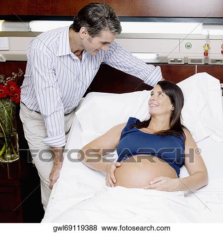 Pregnant woman in a hospital with her husband View Large Photo Image Stock Photo - Pregnant woman in a hospital with her husband. Fotosearch
