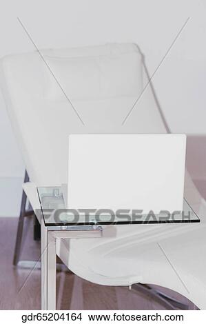 Picture - Reclining chair with a laptop. Fotosearch