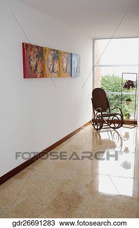 Rocking chair near a window View Large Photo Image Stock Image - Rocking chair near a window. Fotosearch