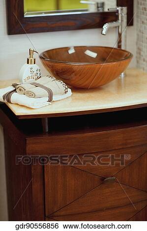 Soap dispenser and towels on a bathroom sink View Large Photo Image Stock Photograph - Soap dispenser and towels on a bathroom sink. Fotosearch