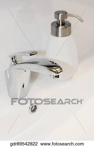 Soap dispenser on a bathroom sink View Large Photo Image Stock Image - Soap dispenser on a bathroom sink. Fotosearch
