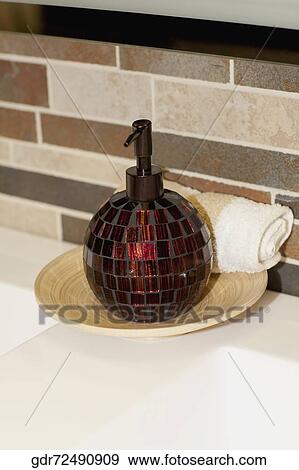 Soap dispenser on a bathroom sink View Large Photo Image Stock Photo - Soap dispenser on a bathroom sink. Fotosearch