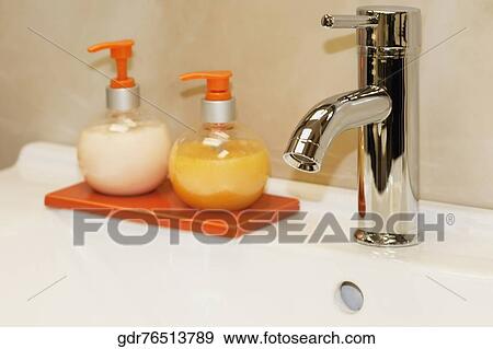 Soap dispensers on a bathroom sink View Large Photo Image Stock Photo - Soap dispensers on a bathroom sink. Fotosearch