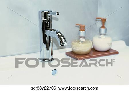 Soap dispensers on a bathroom sink View Large Photo Image Stock Photograph - Soap dispensers on a bathroom sink. Fotosearch