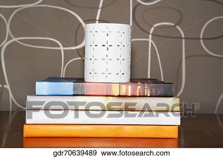 Stack of books with a pen stand View Large Photo Image Stock Photo - Stack of books with a pen stand. Fotosearch