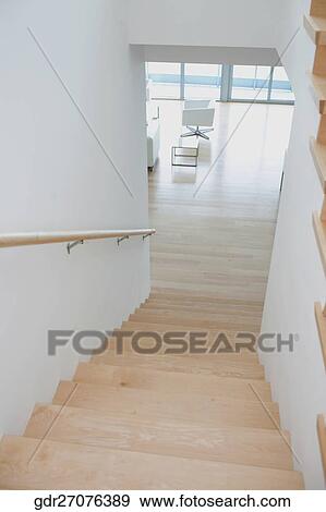Stock Photo - Staircase leading towards a living room. Fotosearch