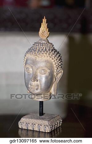 Statue of Buddha on a table View Large Photo Image Stock Photography - Statue of Buddha on a table. Fotosearch