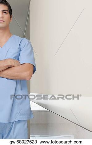 Surgeon standing in the corridor of a hospital View Large Photo Image Stock Image - Surgeon standing in the corridor of a hospital. Fotosearch