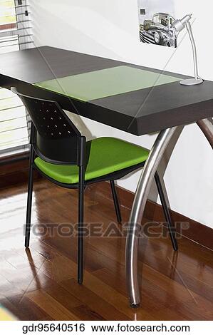 Table lamp and chair in a study room View Large Photo Image Stock Photograph - Table lamp and chair in a study room. Fotosearch
