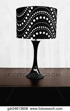 Table lamp on a sideboard View Large Photo Image Stock Photo - Table lamp on a sideboard. Fotosearch