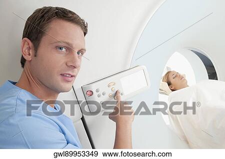 Technician operating an MRI scanner View Large Photo Image Stock Photo - Technician operating an MRI scanner. Fotosearch
